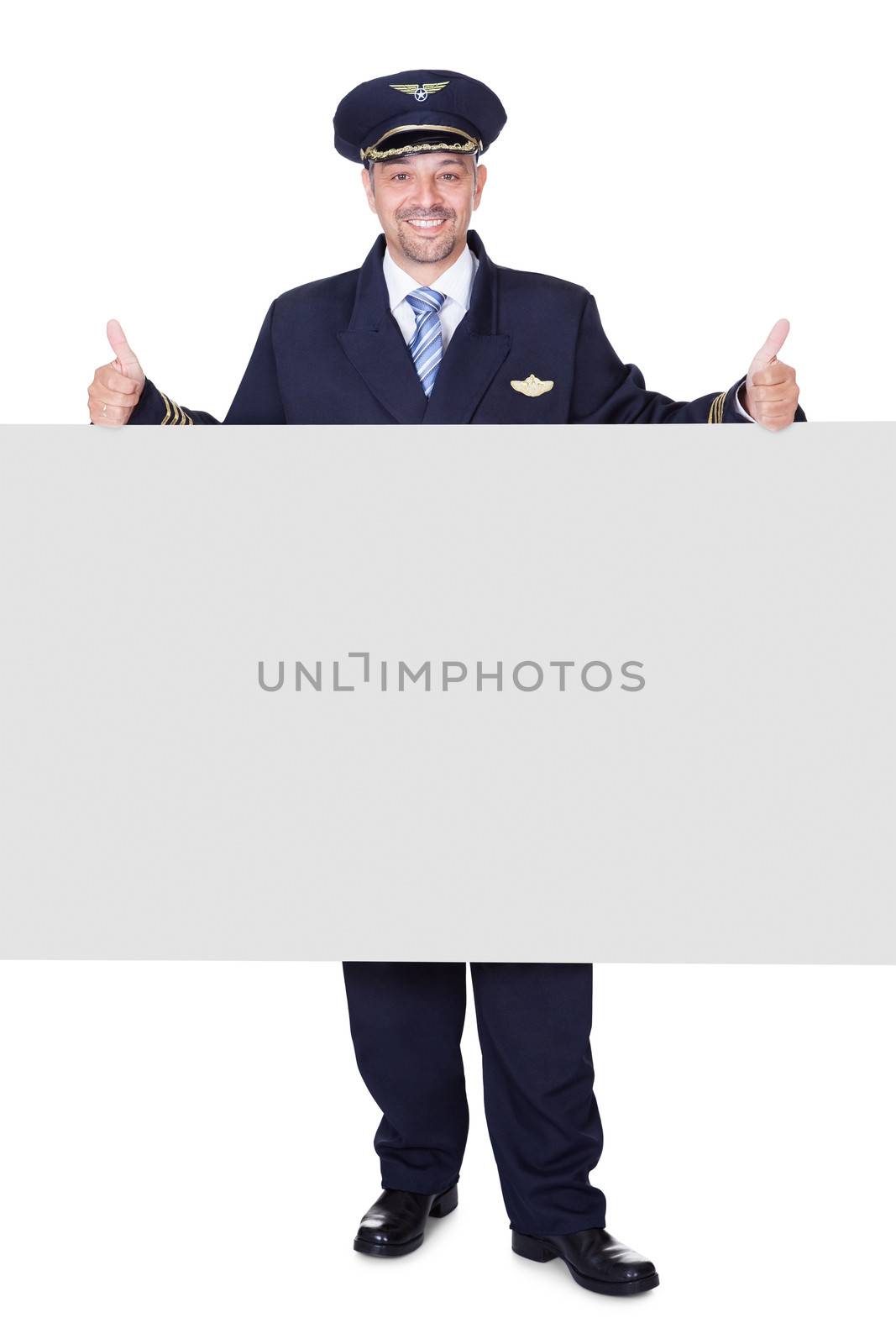 Portrait Of Happy Pilot Holding Blank Placard On White Background