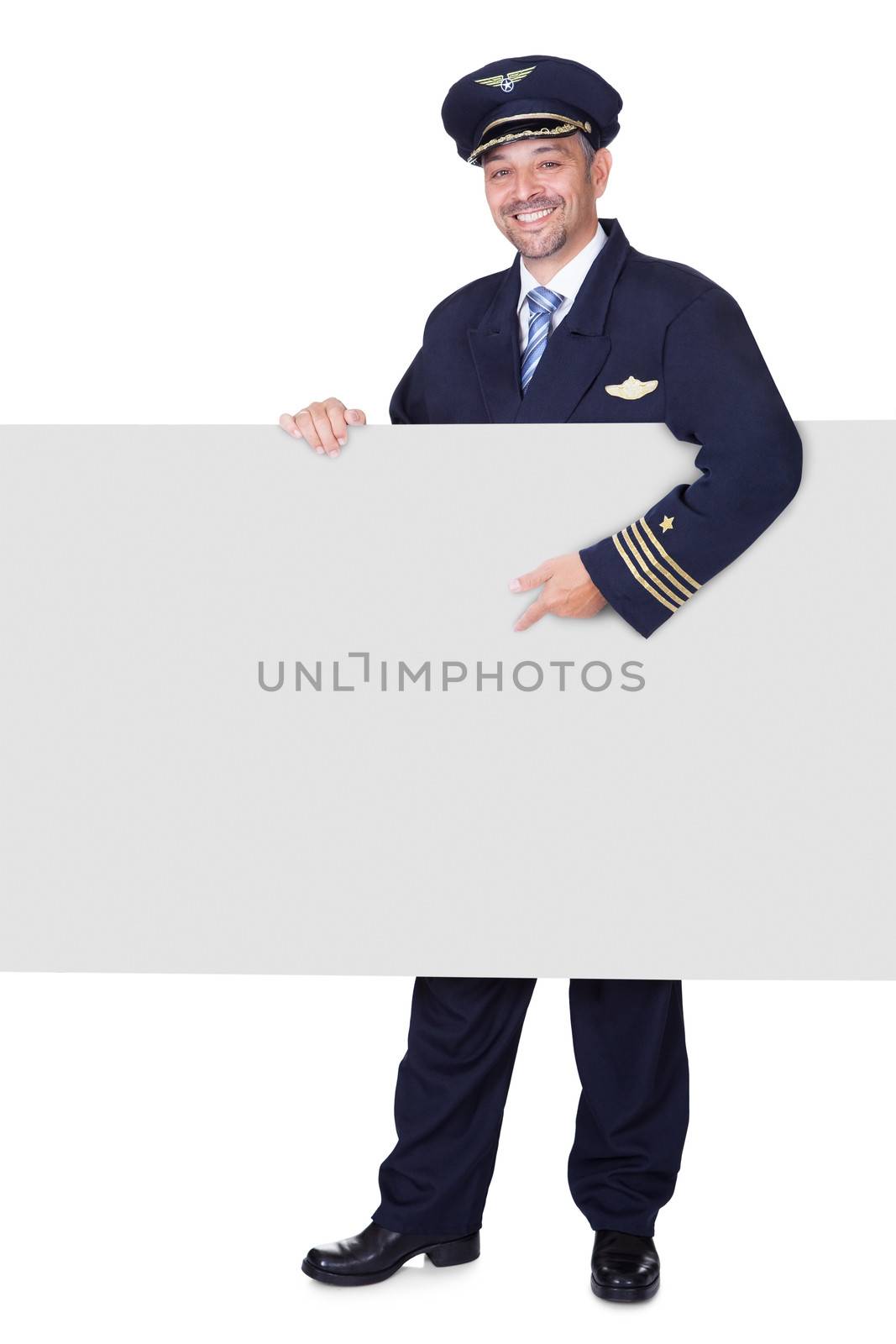 Portrait Of Happy Pilot Holding Blank Placard On White Background