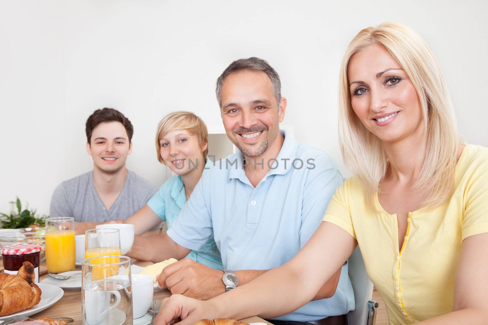 Happy family enjoying breakfast by AndreyPopov