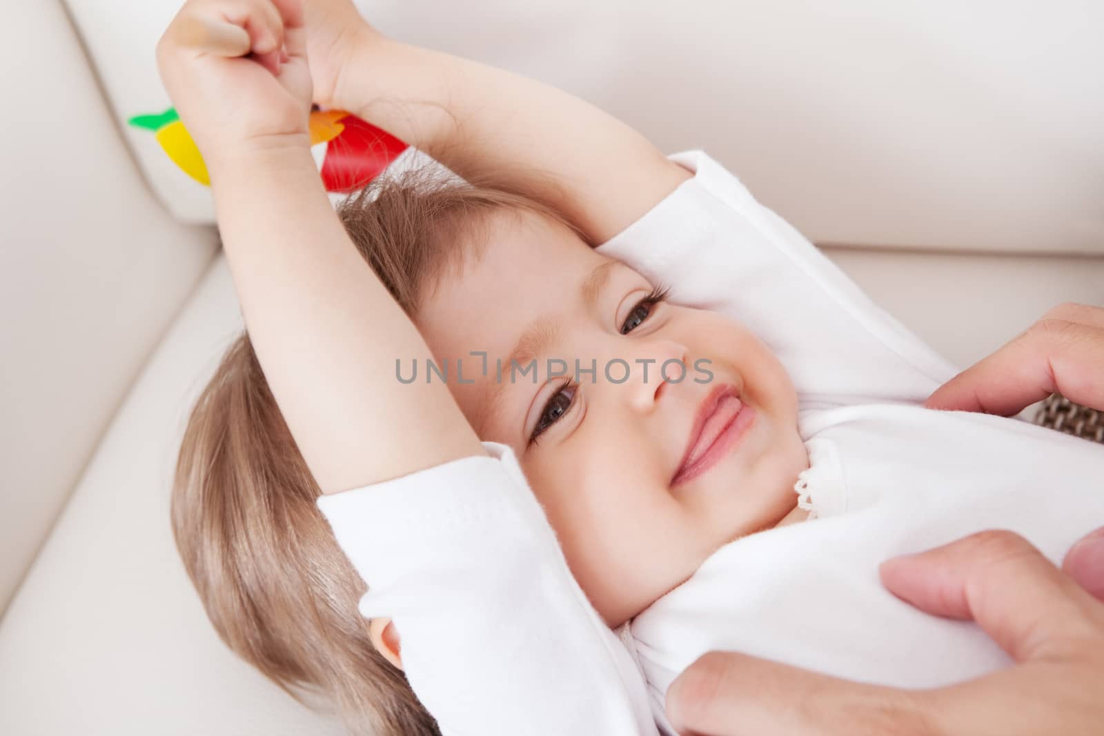 Portrait of a cute innocent young baby smiling and looking with enjoyment