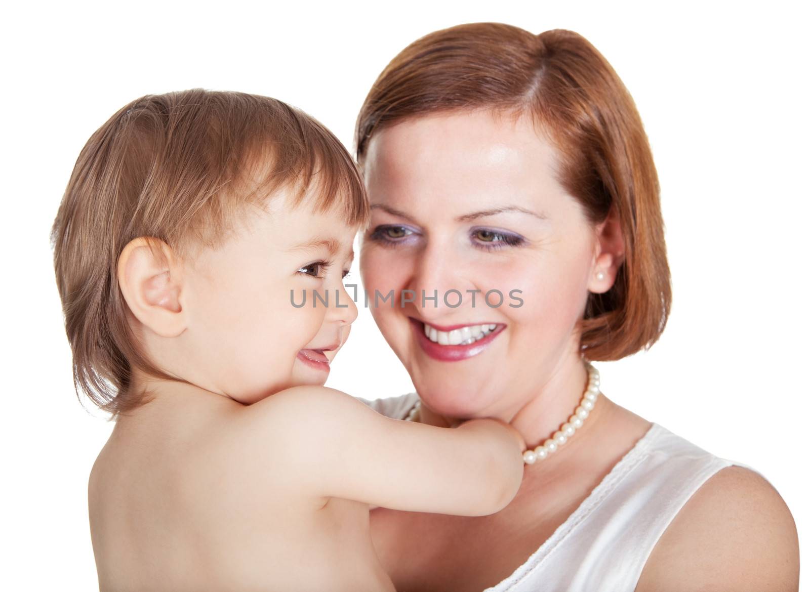 Tender moment between Mum and her baby little daughter as they smile into each others eyes with their heads close together