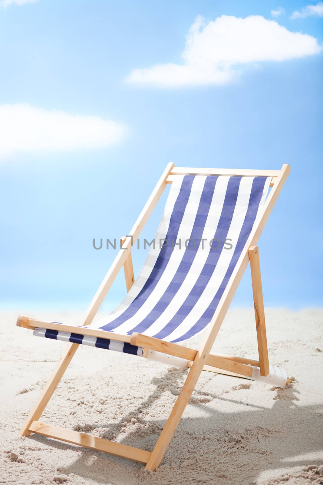 Deckchair standing at the sunny beach by AndreyPopov