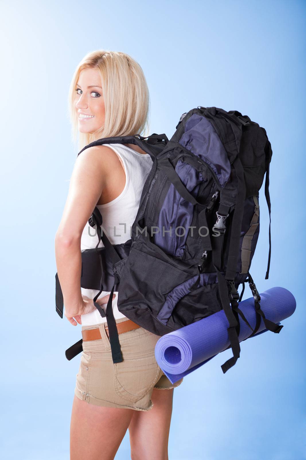 Portrait of beautiful young hiking woman with backpack
