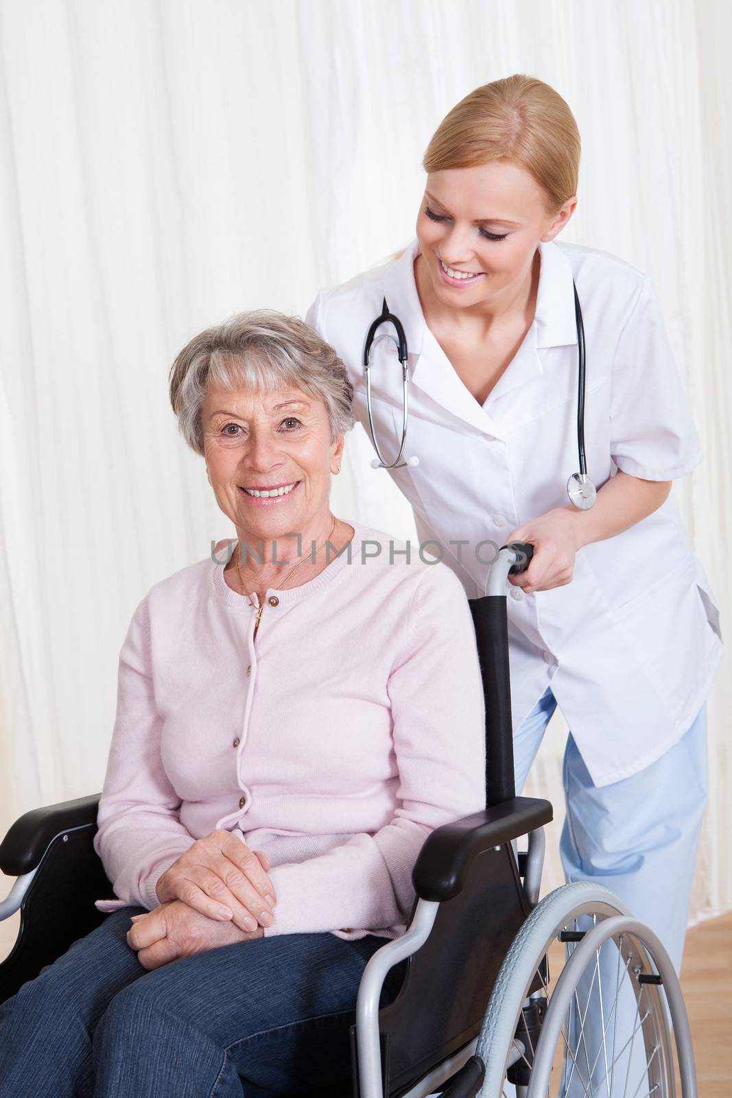 Caring Doctor Helping Handicapped Patient by AndreyPopov
