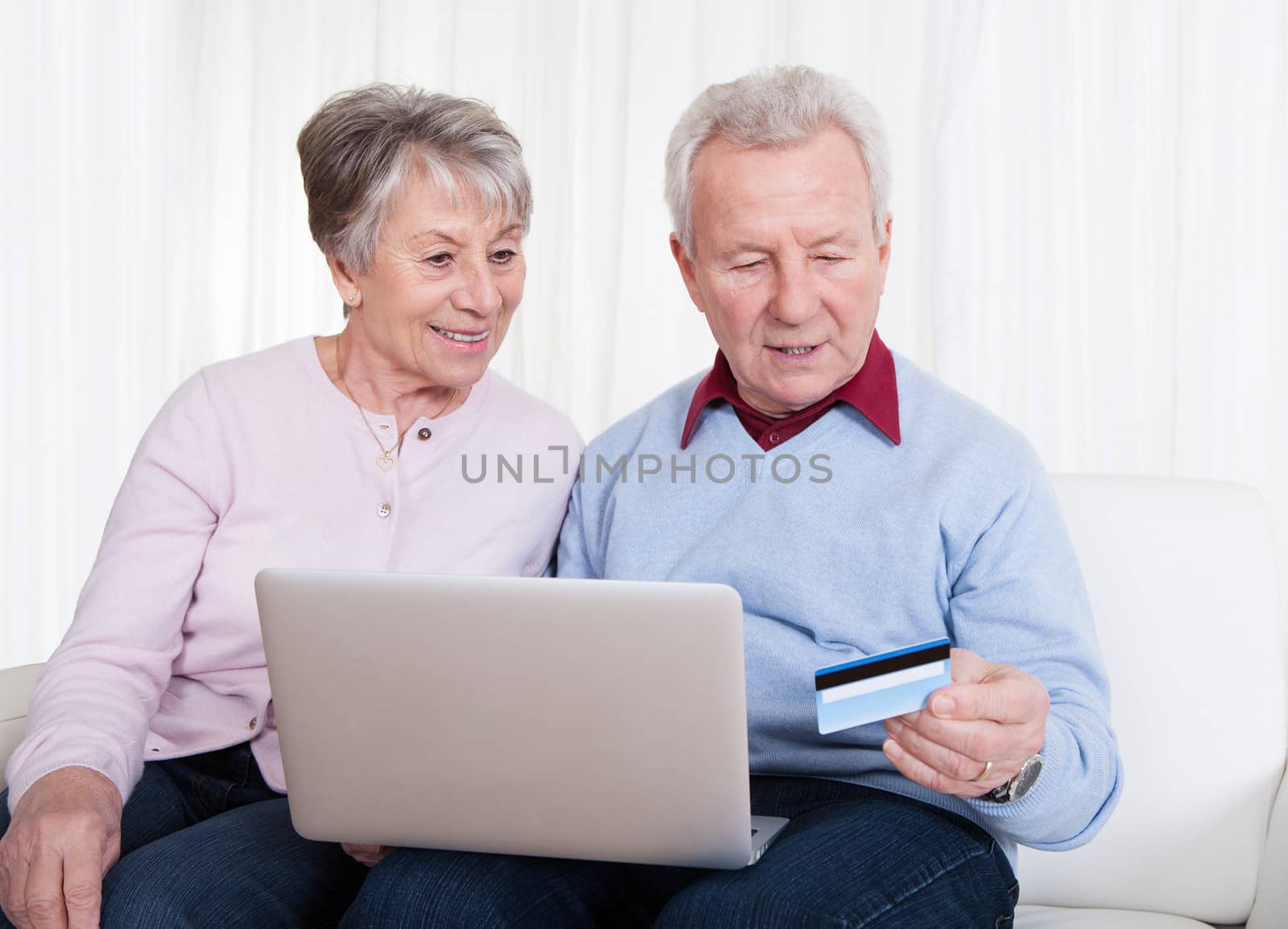 Senior Couple Shopping Online by AndreyPopov