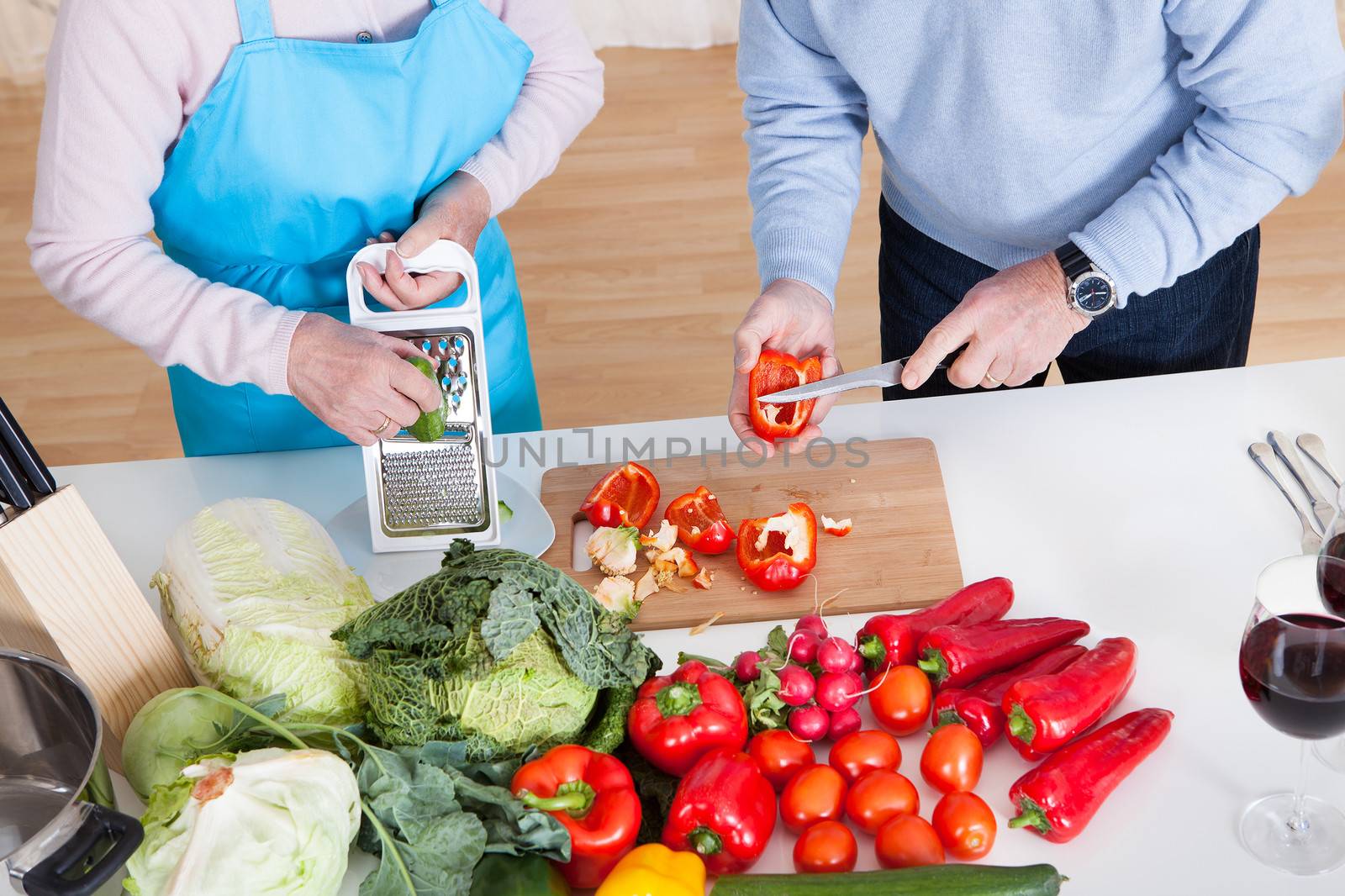 Senior Couple Cutting Vegetables by AndreyPopov