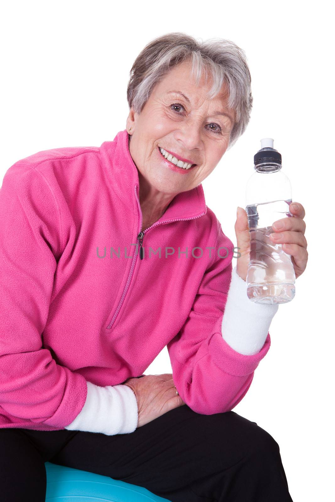 Portrait Of Happy Senior Woman Holding Water Bottle On White Background