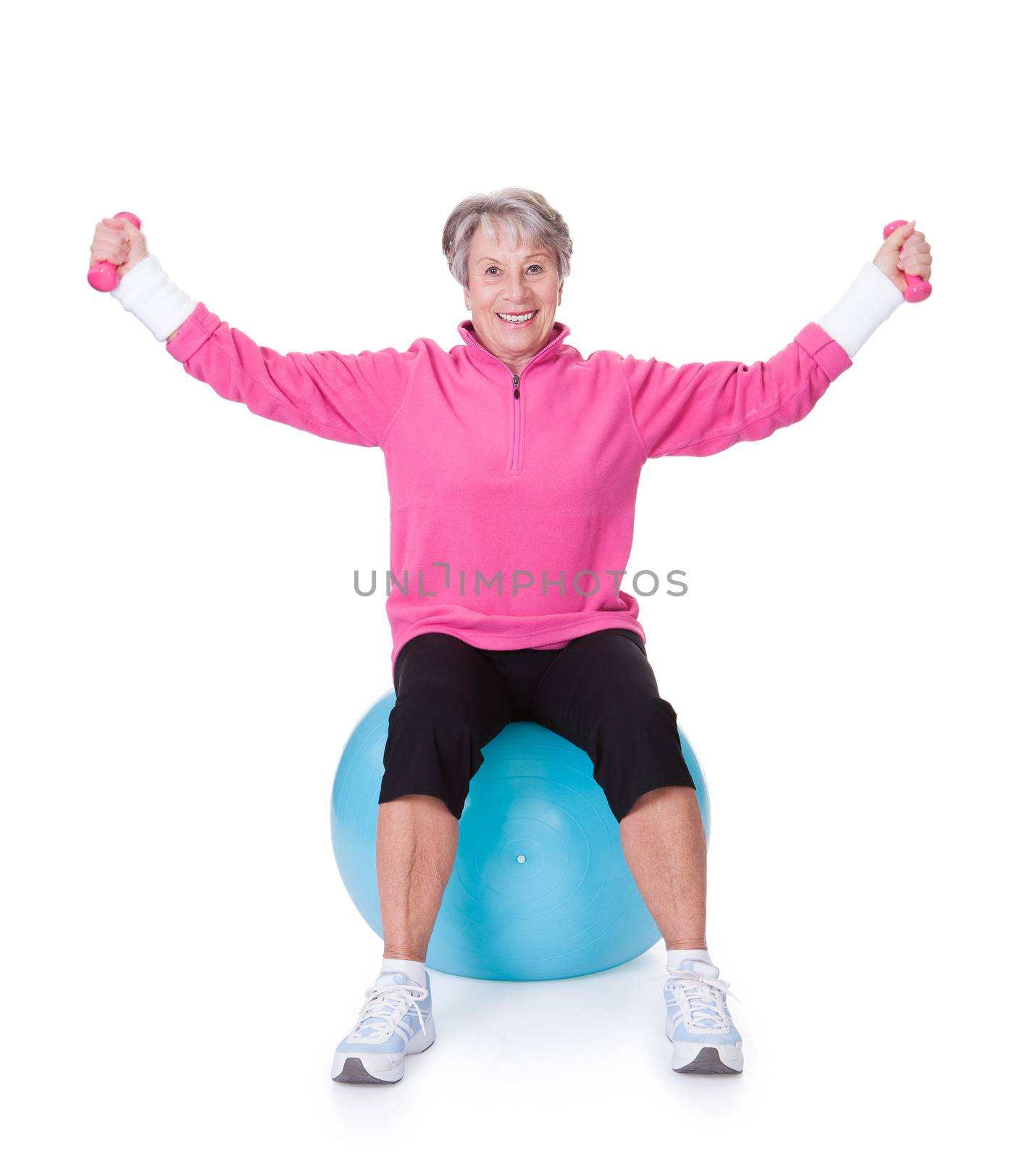 Senior Woman Exercising With Dumbbells by AndreyPopov