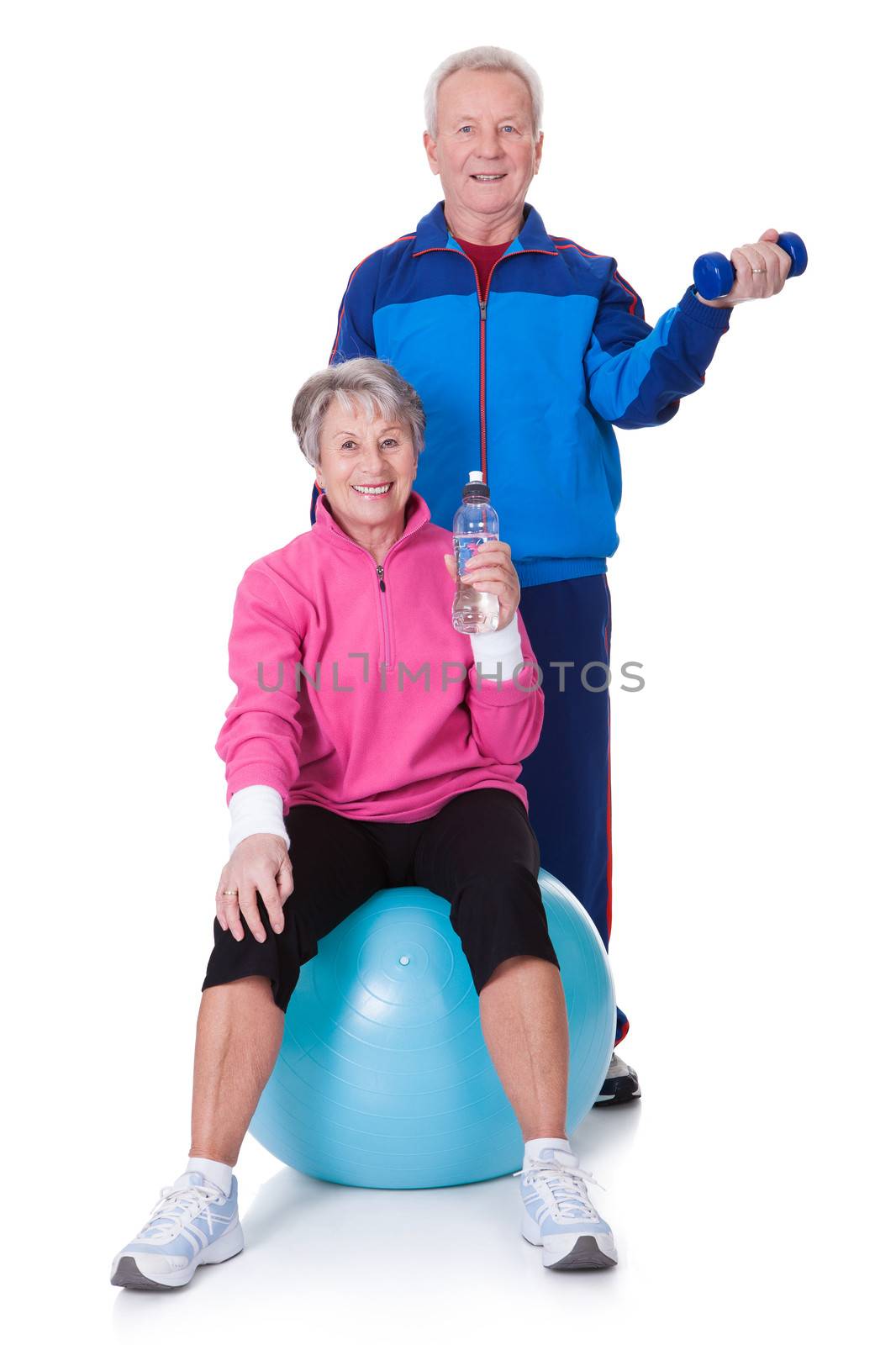 Portrait Of A Senior Couple Exercising On White Background
