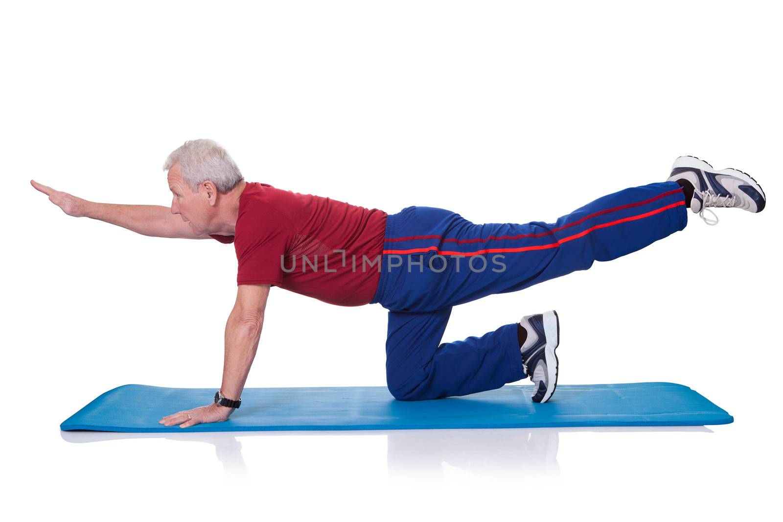 Portrait Of Senior Man Exercising On White Background