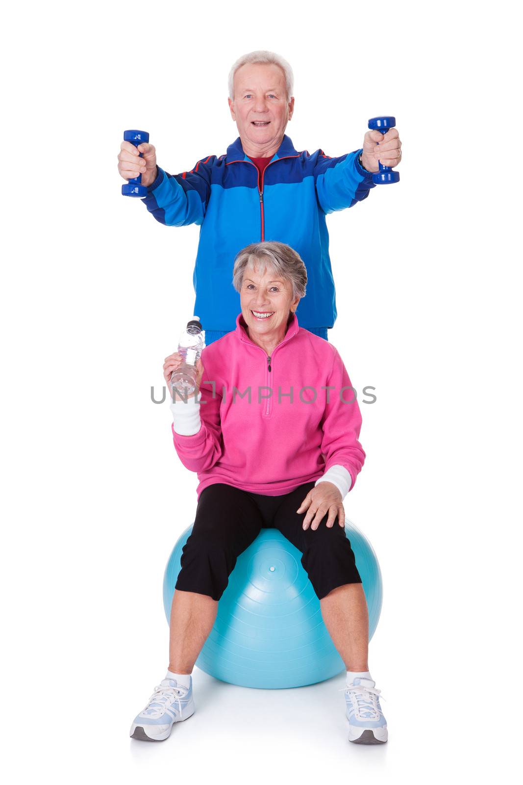 Portrait Of A Senior Couple Exercising On White Background
