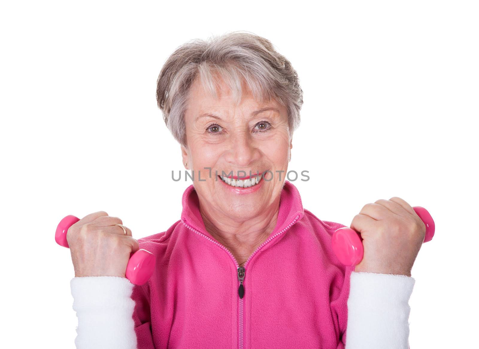 Portrait Of A Senior Woman Exercising On White Background