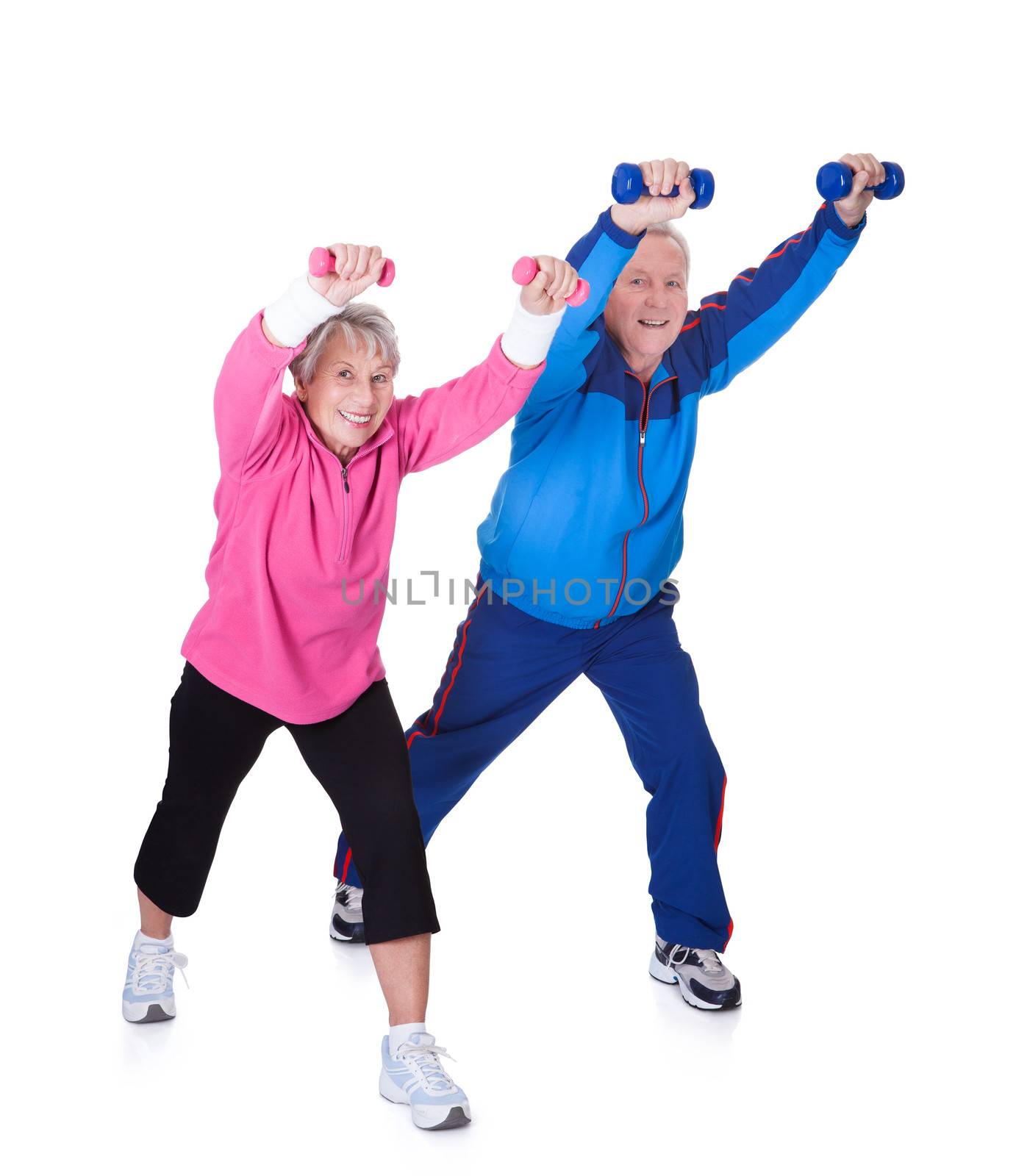 Portrait Of A Senior Couple Exercising On White Background