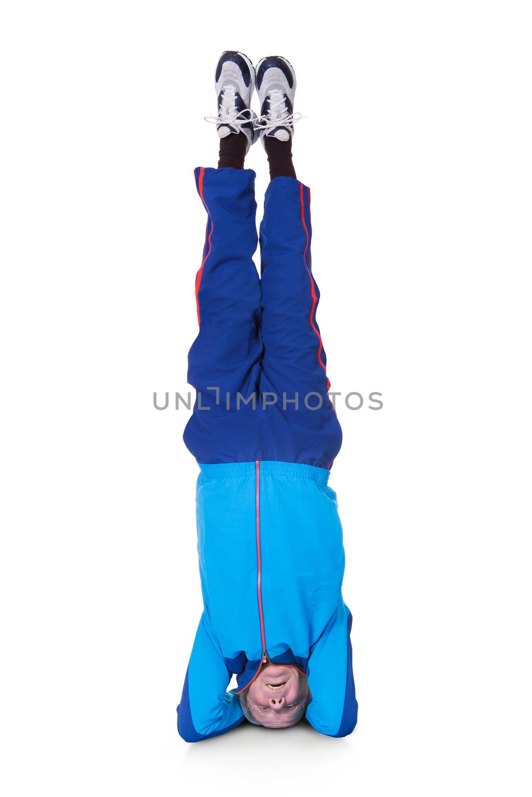 Senior Man Performing Yoga Headstand On White Background