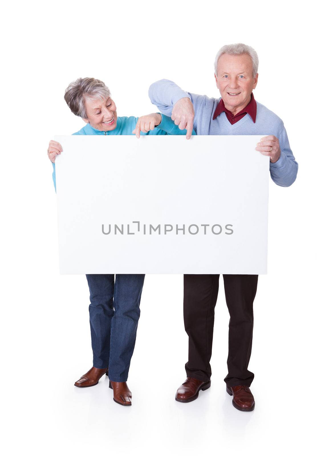 Senior Couple Holding Blank Placard by AndreyPopov
