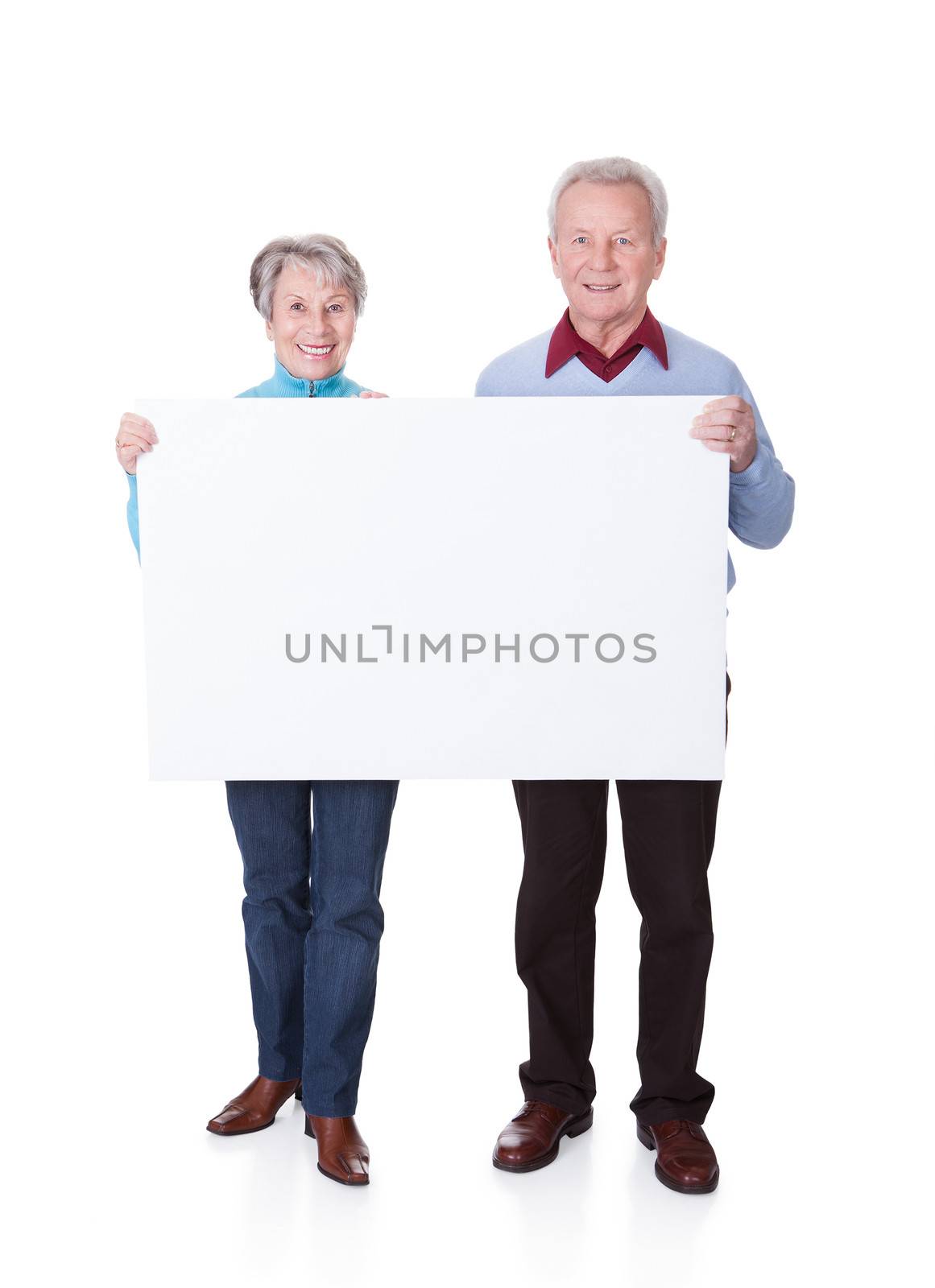 Senior Couple Holding Blank Placard by AndreyPopov