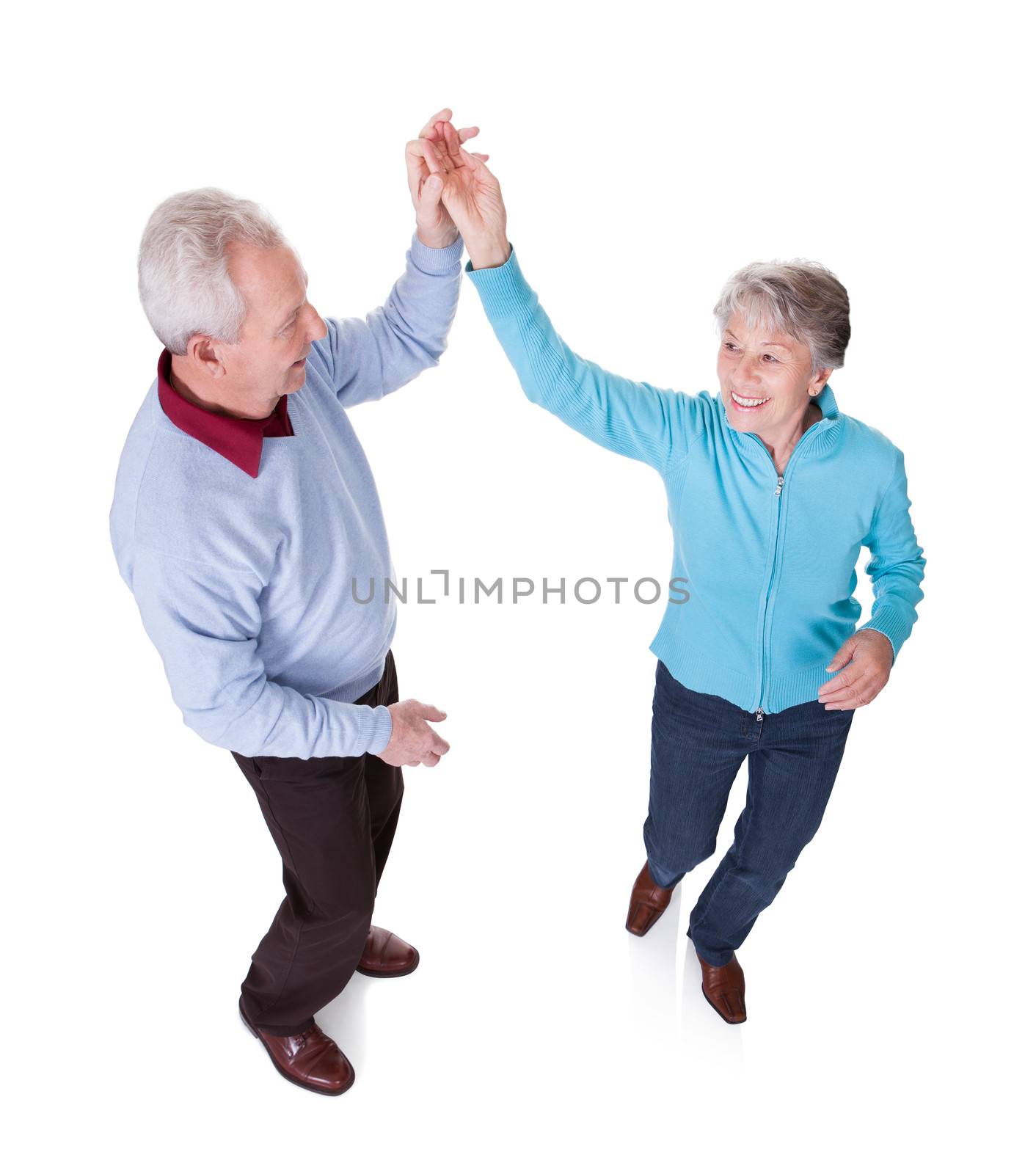 Portrait Of Senior Couple Dancing by AndreyPopov