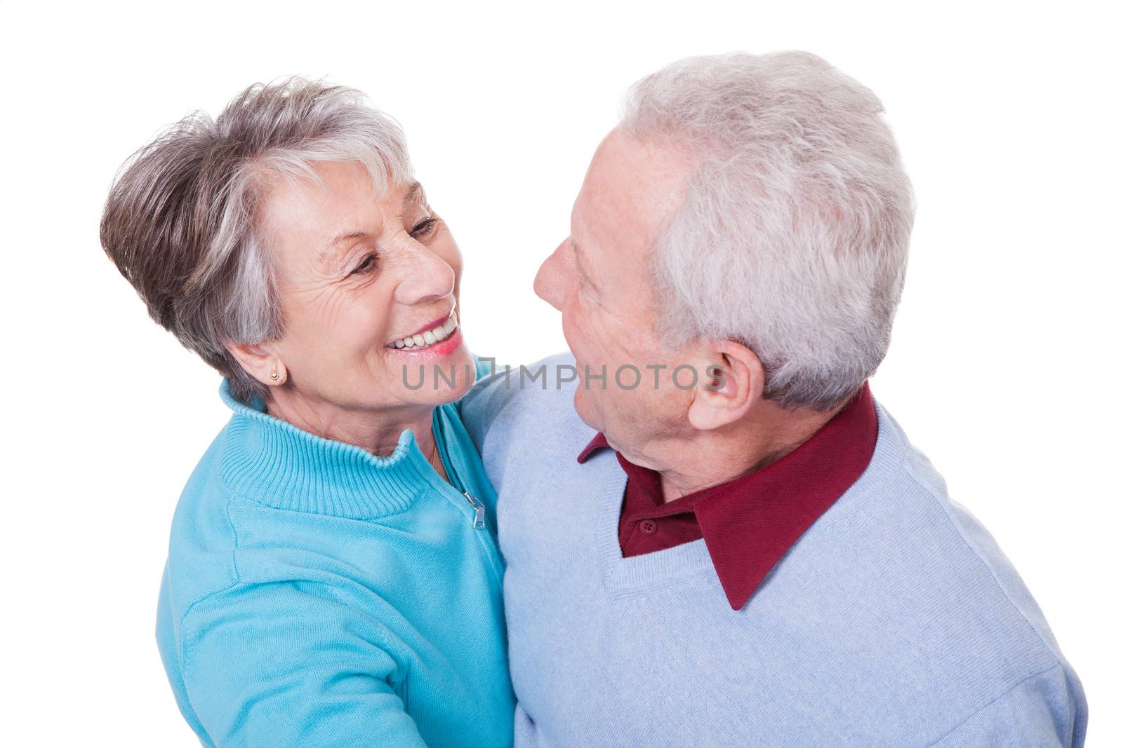 Portrait Of Senior Couple Dancing On White Background