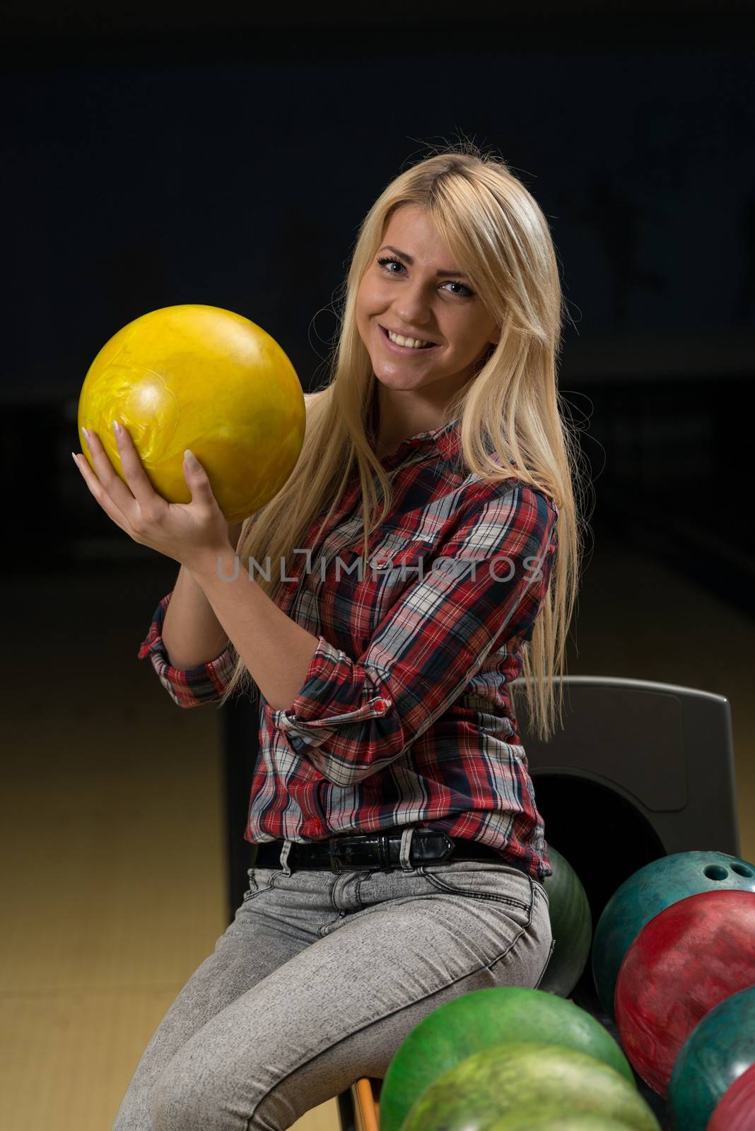 Women Holding A Bowling Ball by JalePhoto