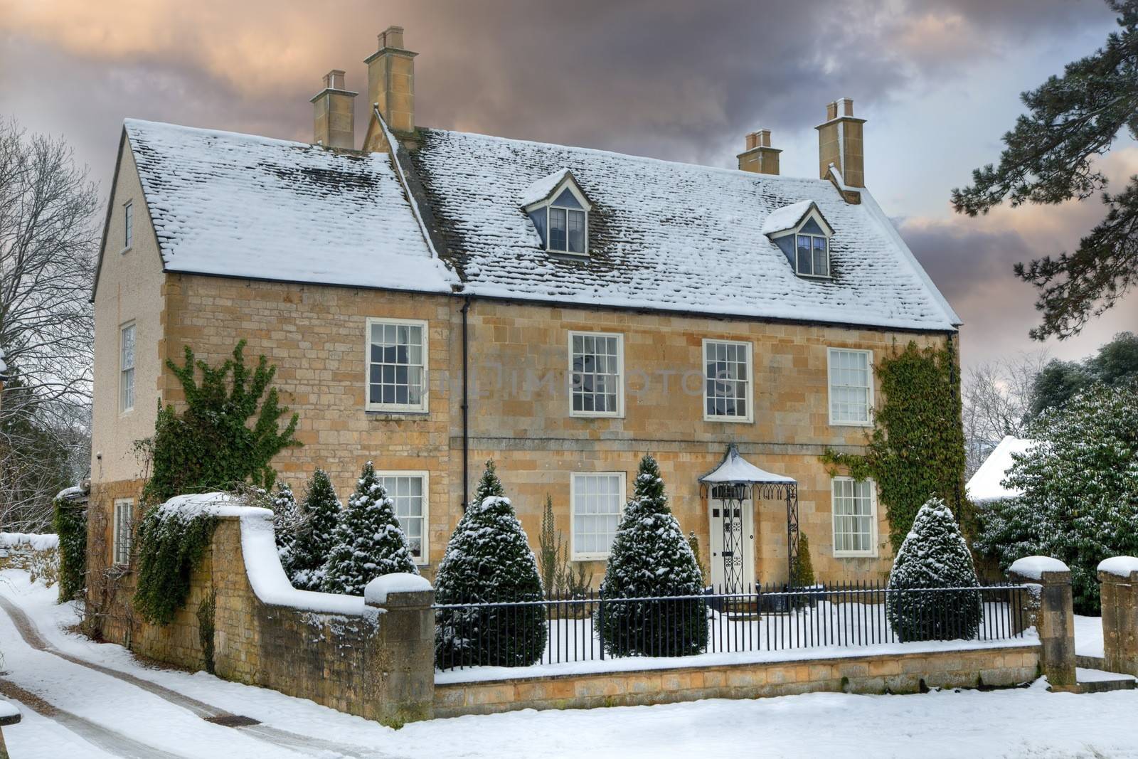 Detached Cotswold house with snow, Broadway, Worcestershire, England.