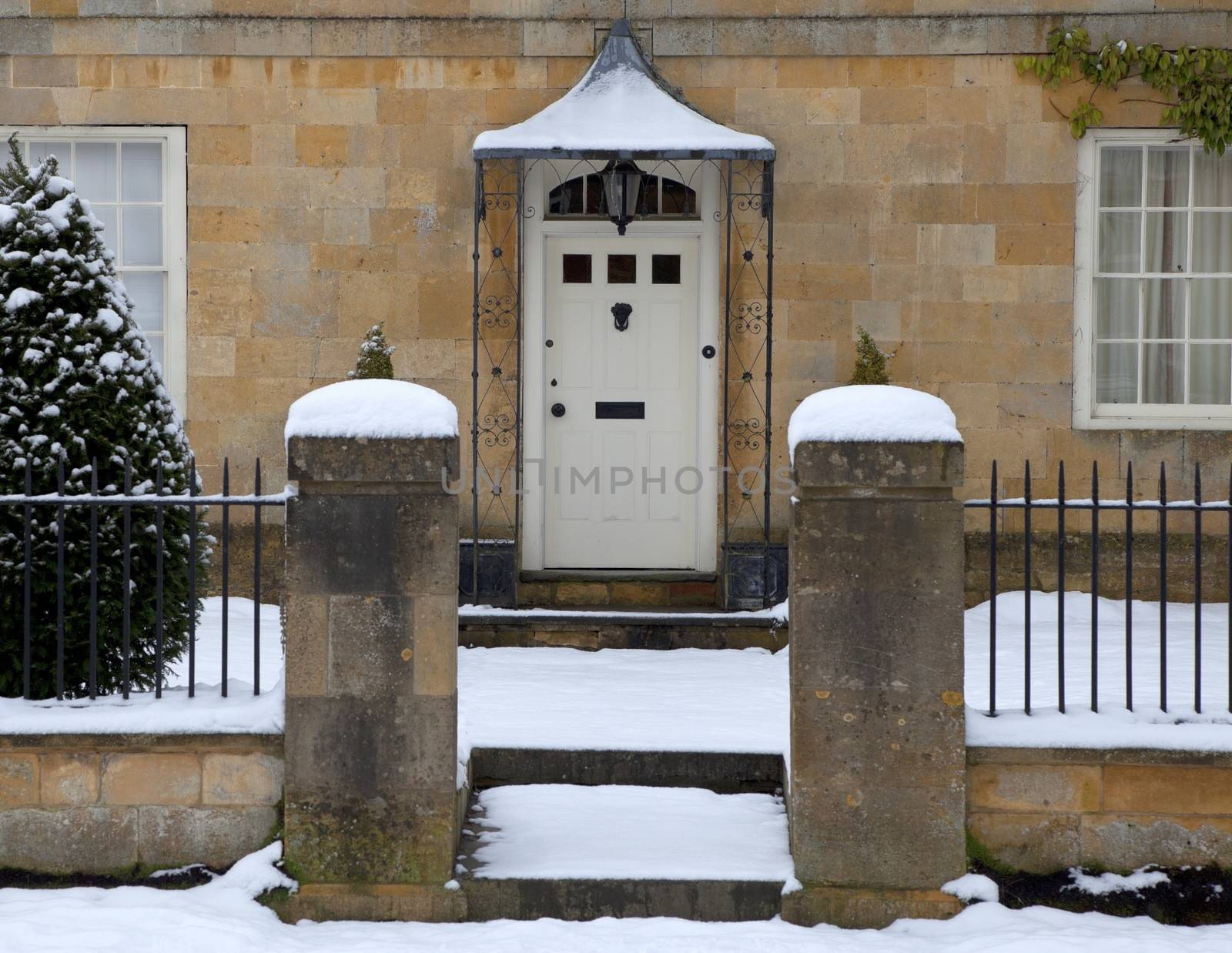 Cotswold house doorway in snow, Broadway, Worcestershire, England.