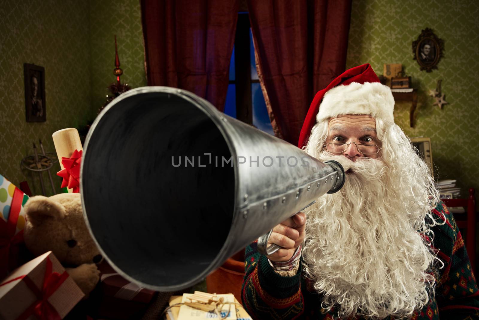 SantaClaus shouting into a vintage megaphone