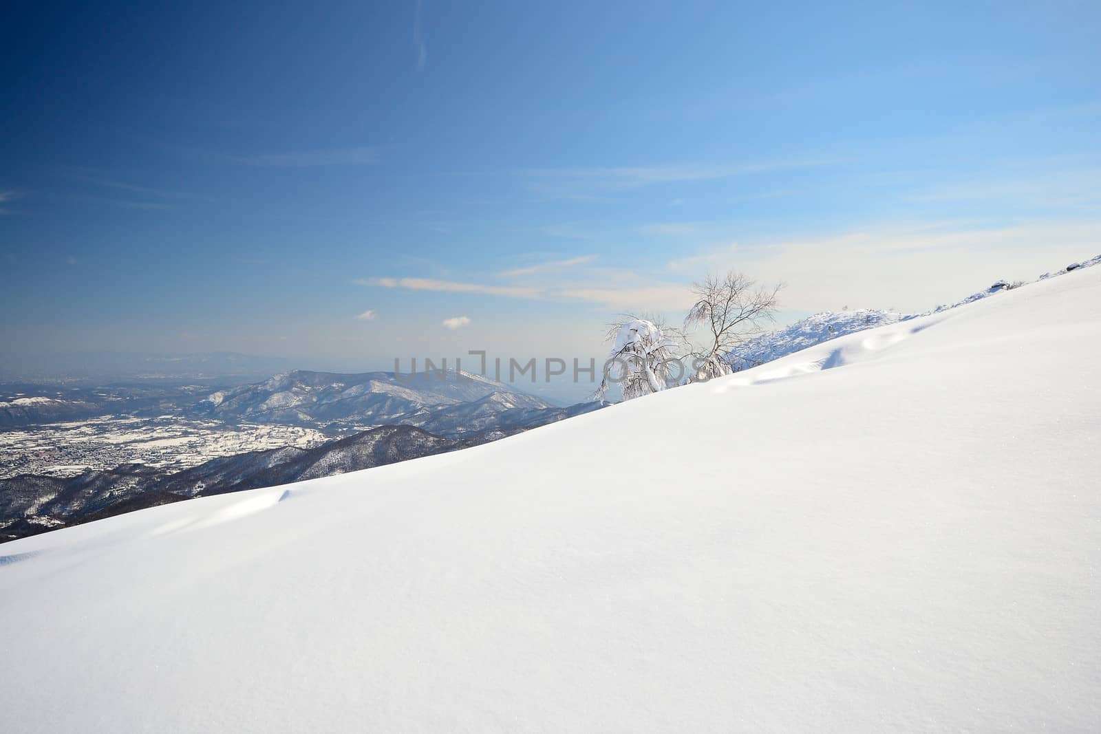 Candid off-piste ski slope in scenic background of high mountain peak