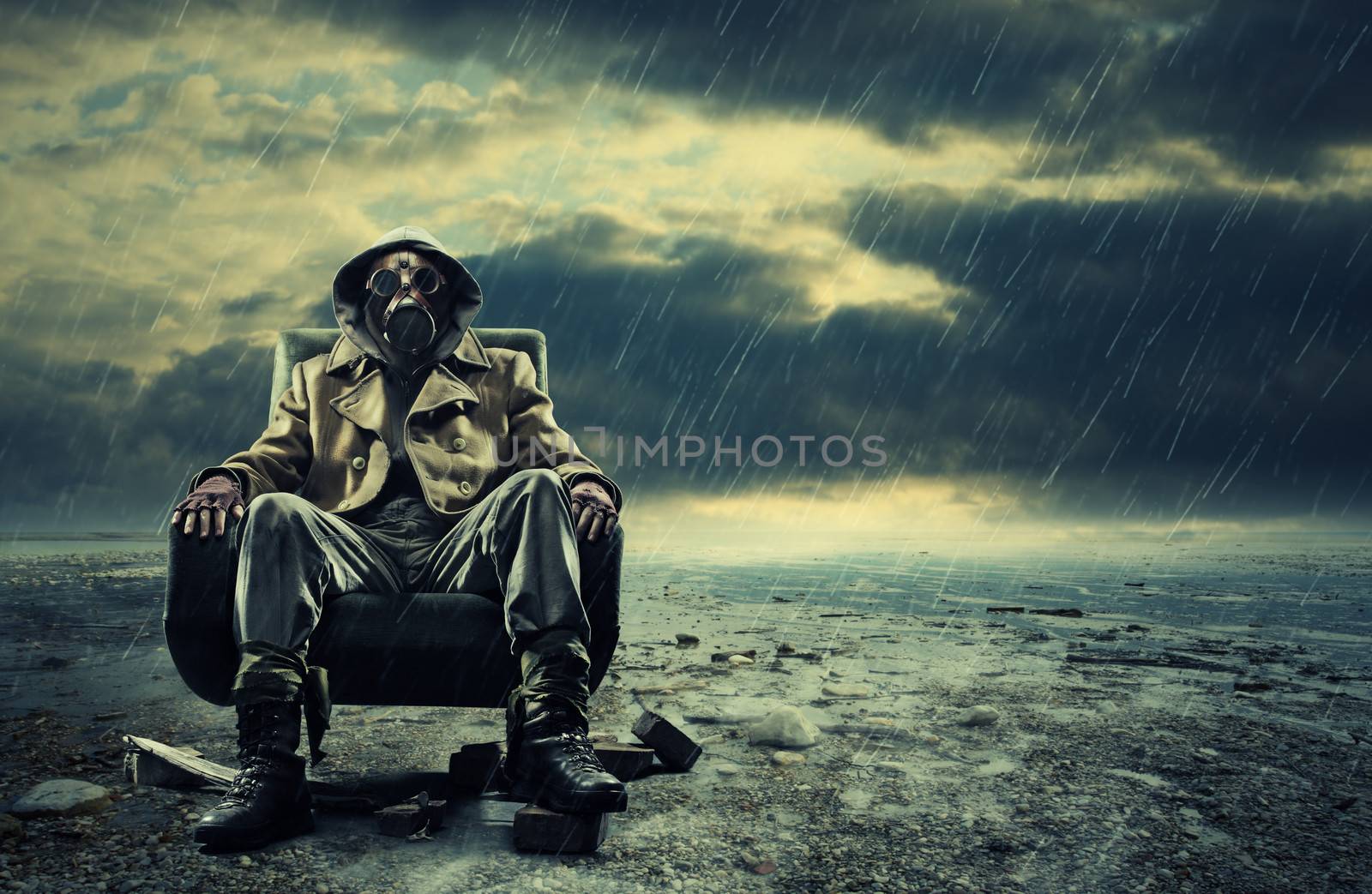 A lonely hero wearing gas mask sitting on armchair