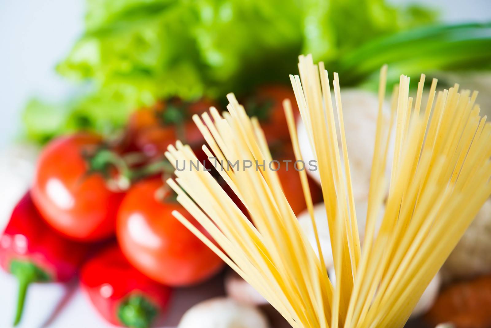 Raw Pasta spaghetti with vegetables close up