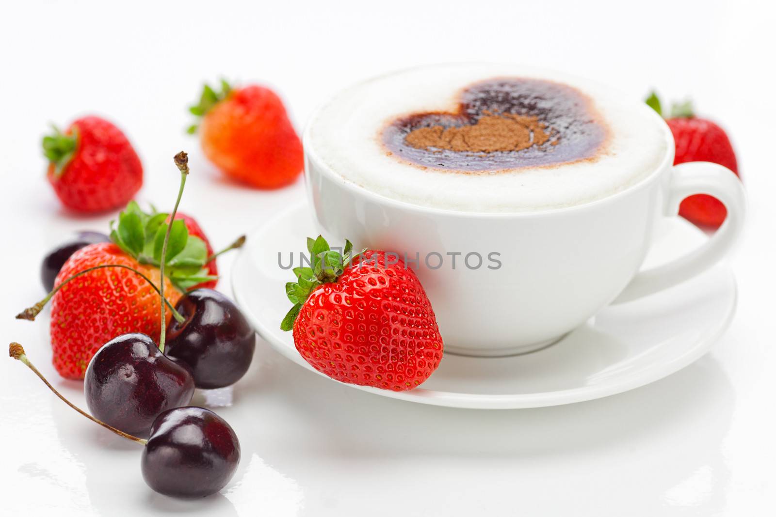 cappuccino in a cup in the shape of hearts,cherry  and strawberries isolated on white