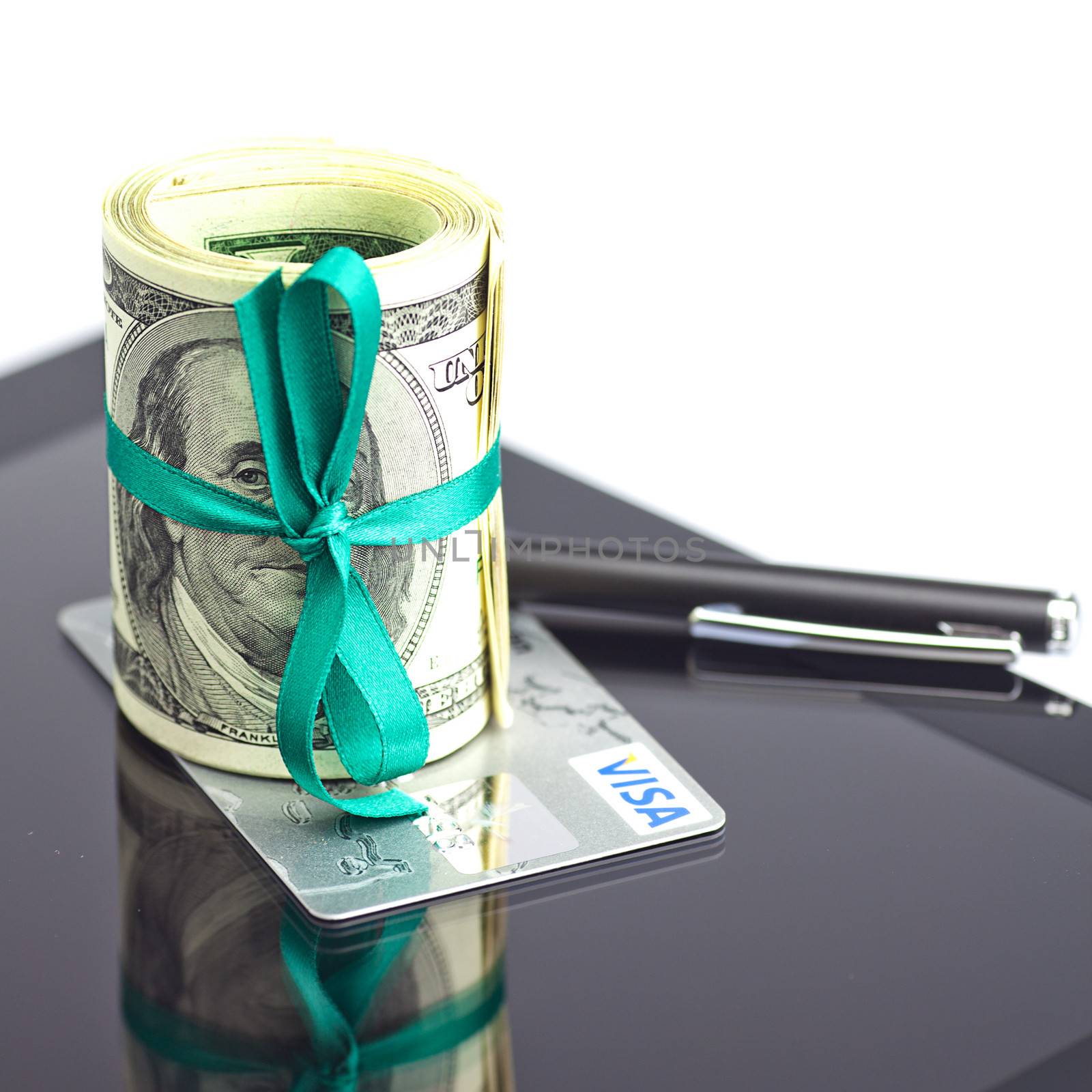 tablet,tube of dollars,credit card and stylus isolated on white