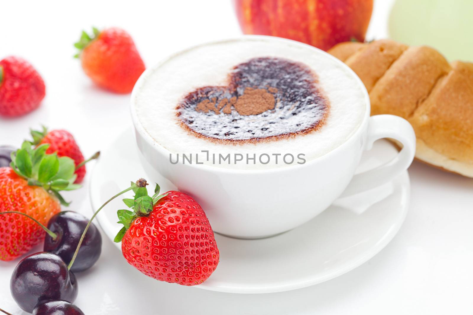 cappuccino in a cup in the shape of hearts,cherry,croissant  and strawberries isolated on white