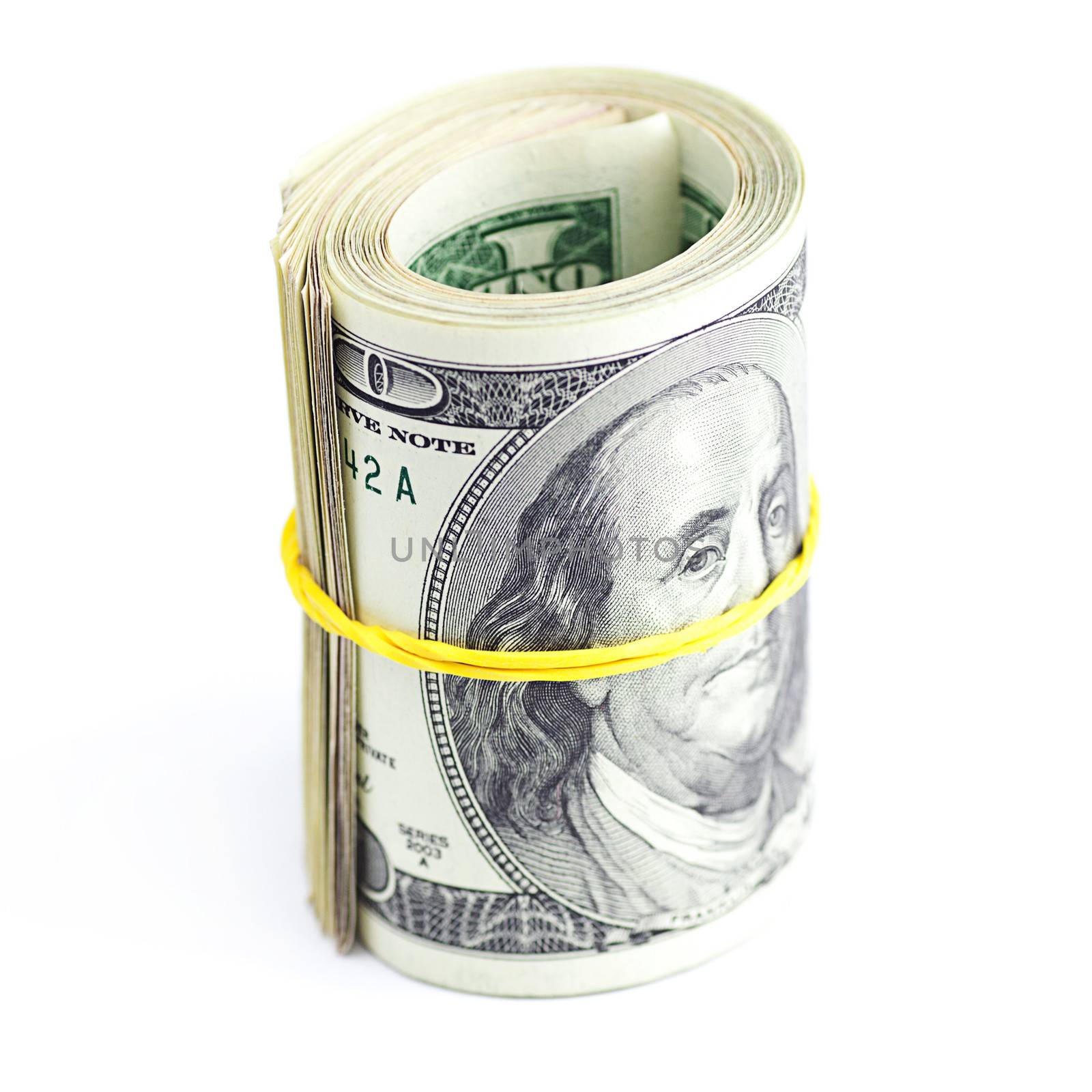 Dollars rolled into a tube tied with an elastic band isolated on white