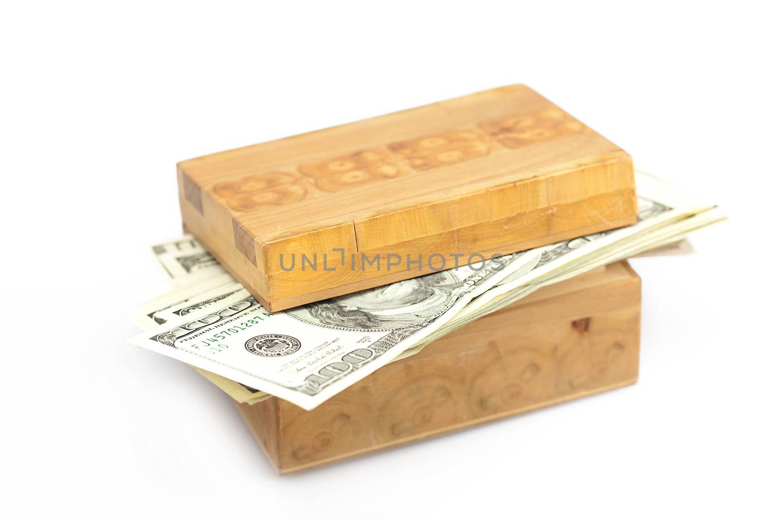 Dollars in the wooden box isolated on white by jannyjus