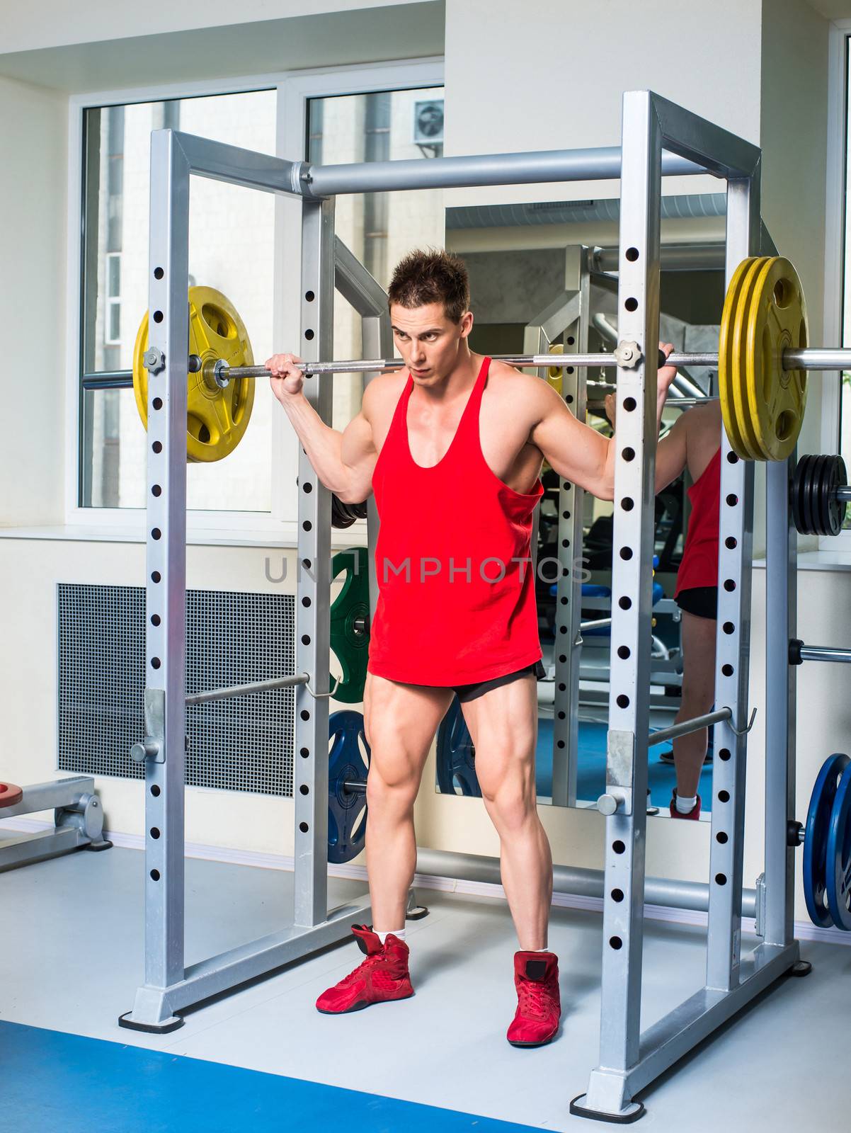 weightlifter squats with a barbell