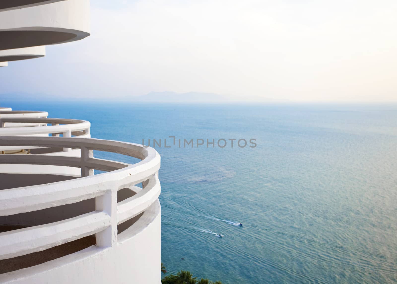 White, curved  balcony looking over beautiful blue ocean