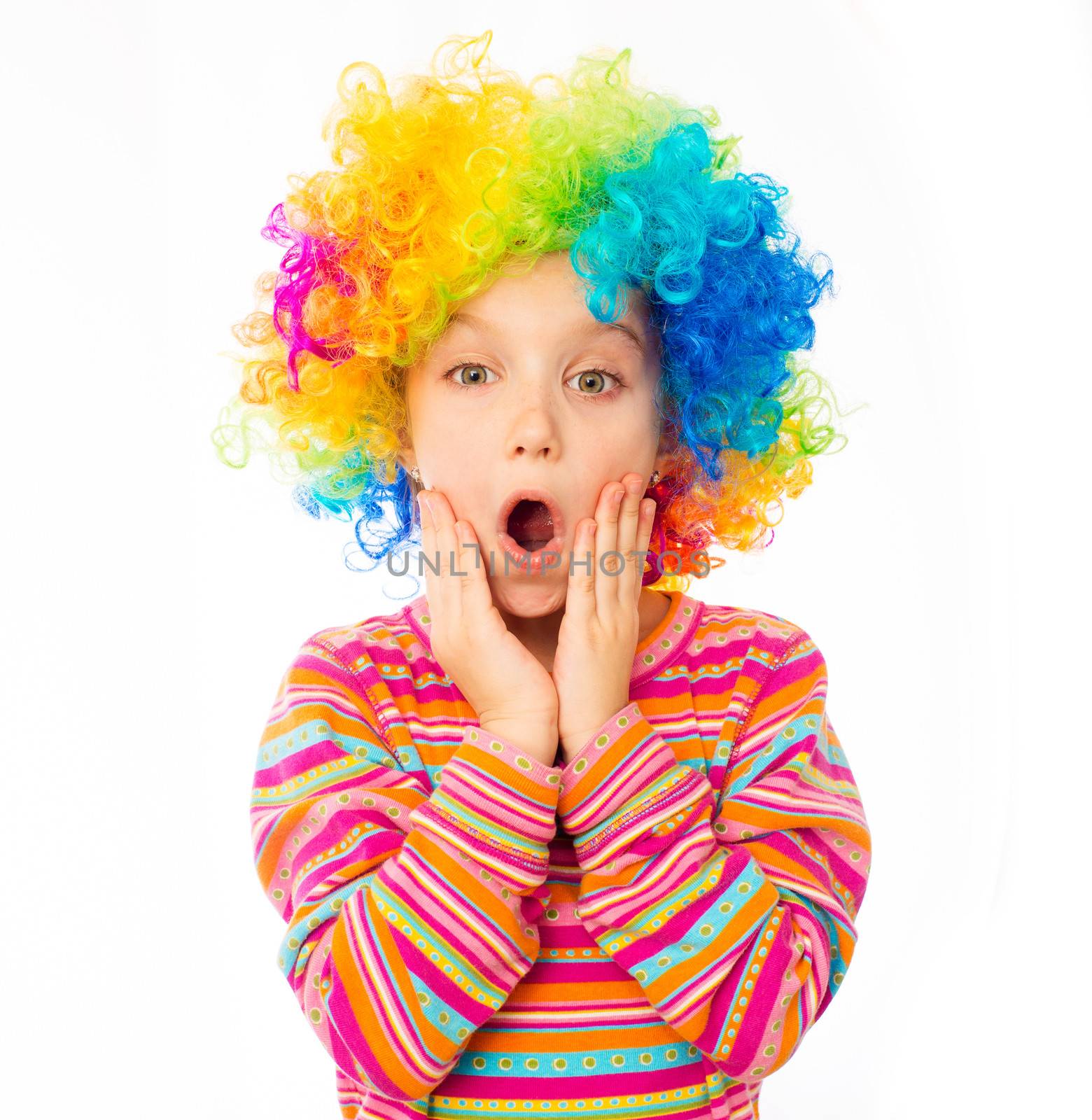 surprised little girl in clown wig isolated on white background