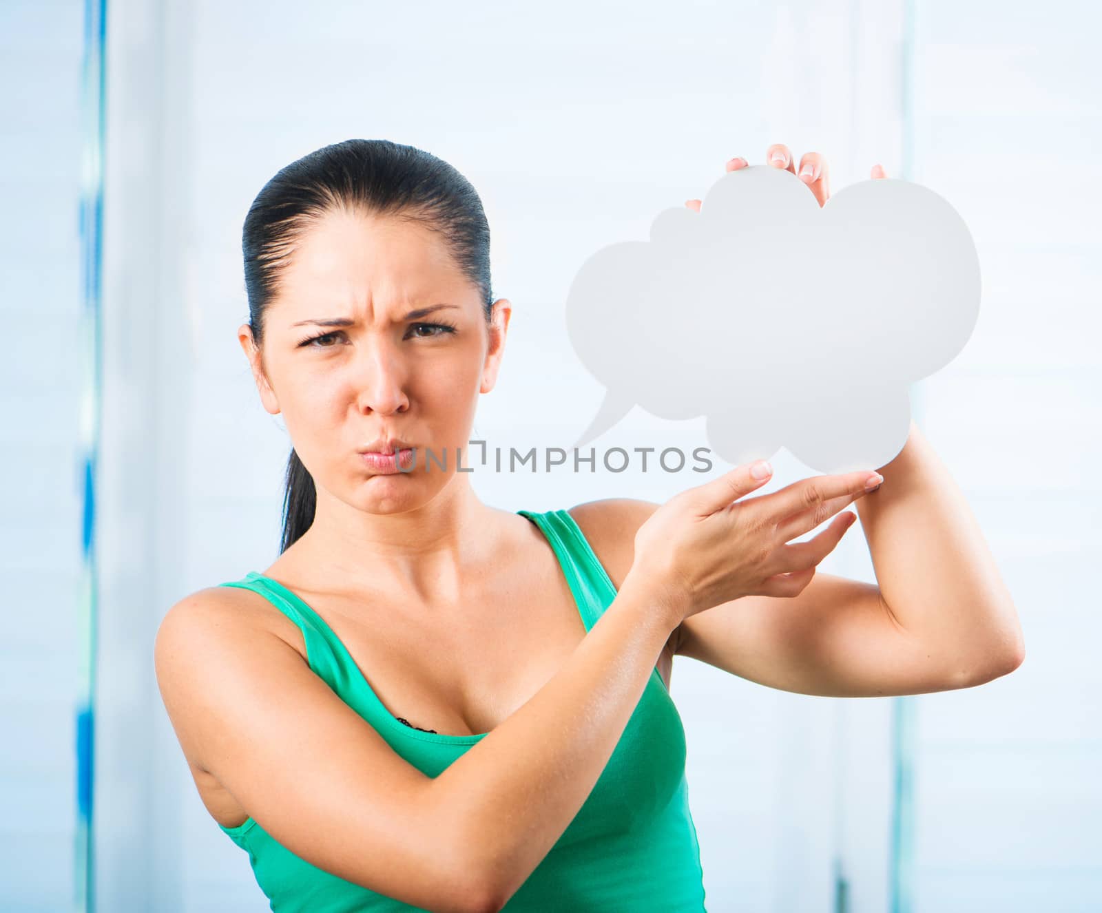sulky young brunette woman holding a white cloud for text