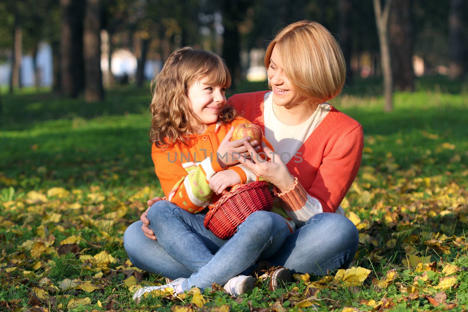 Mom and daughter eating apples by goce