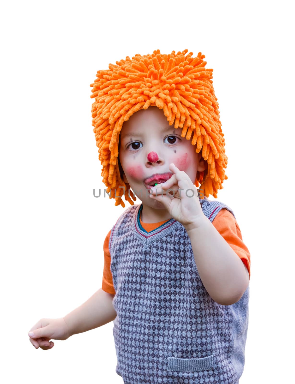 Portrait of cute clown child eating a lollipop isolated on white background