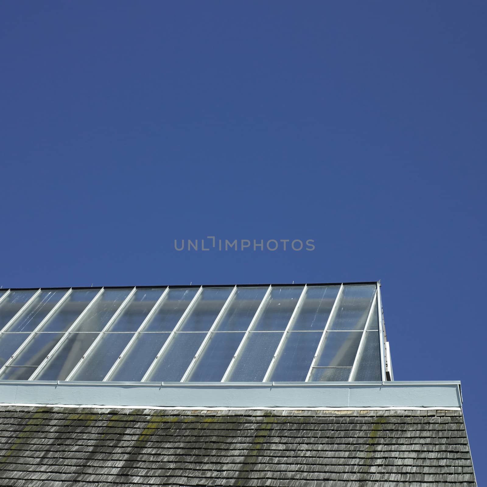 Building with glass roof and shingled wall