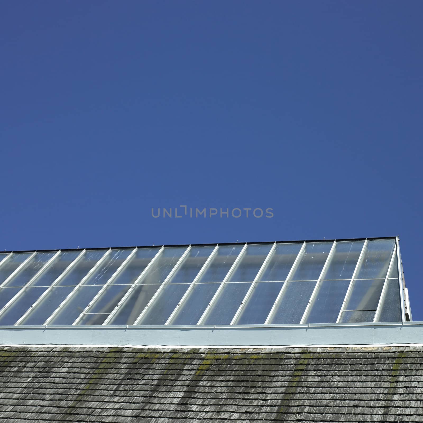 Building with glass roof and shingled wall