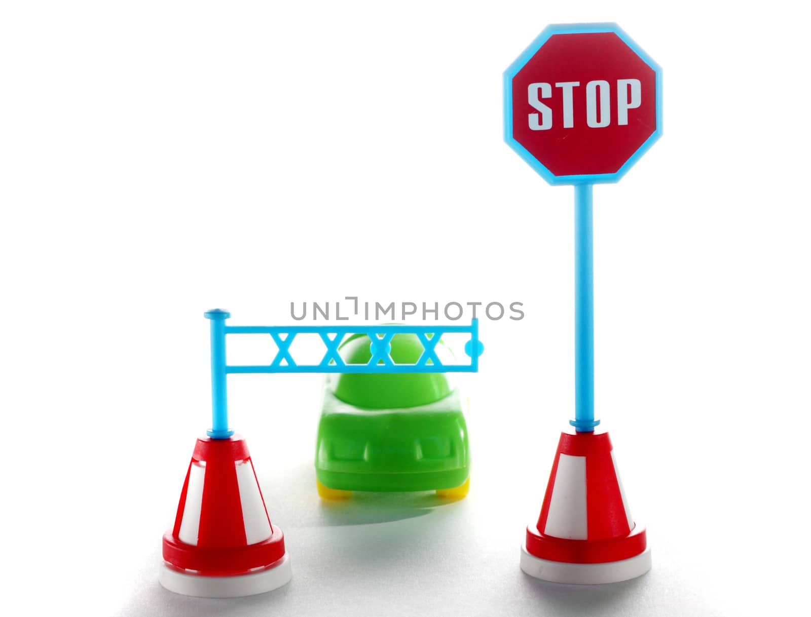 Car behind barrier with stop road sign on white background