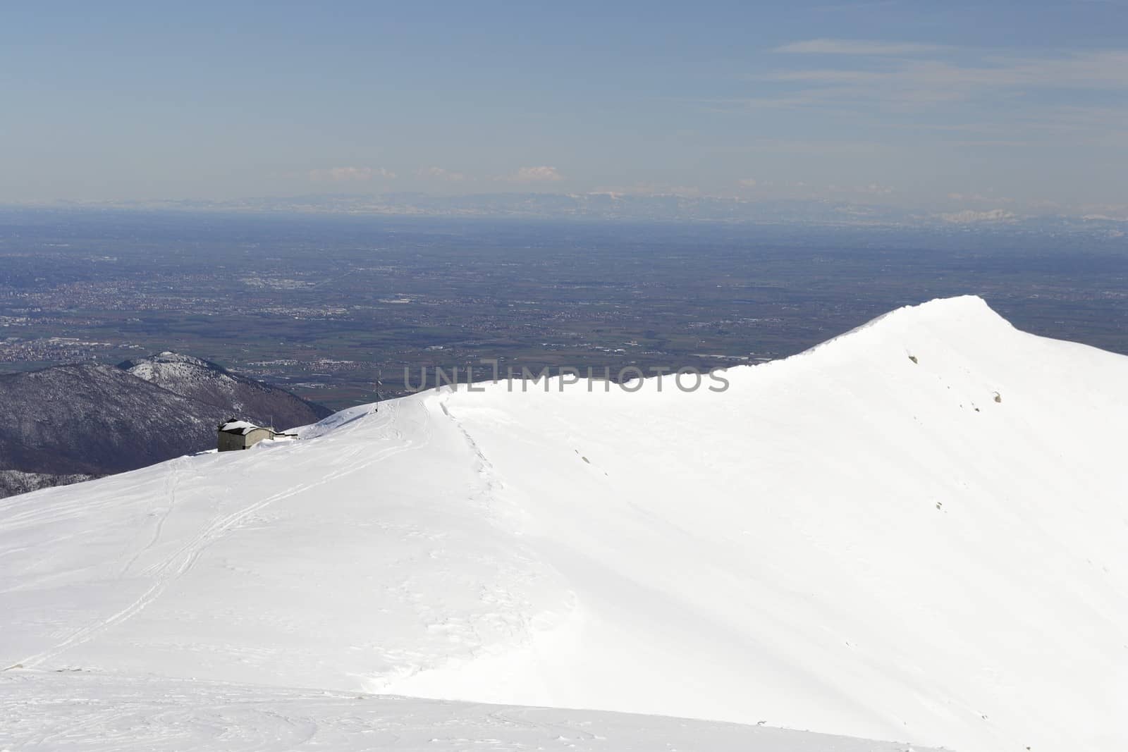 Candid off-piste ski slope in scenic background of high mountain peak