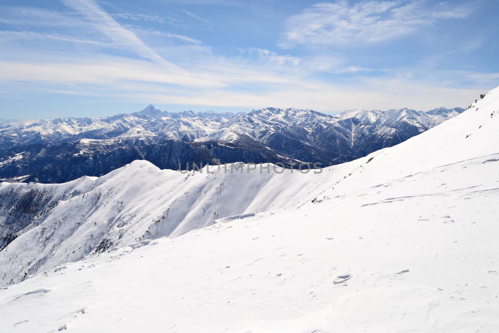 Candid off-piste ski slope in scenic background of high mountain peak