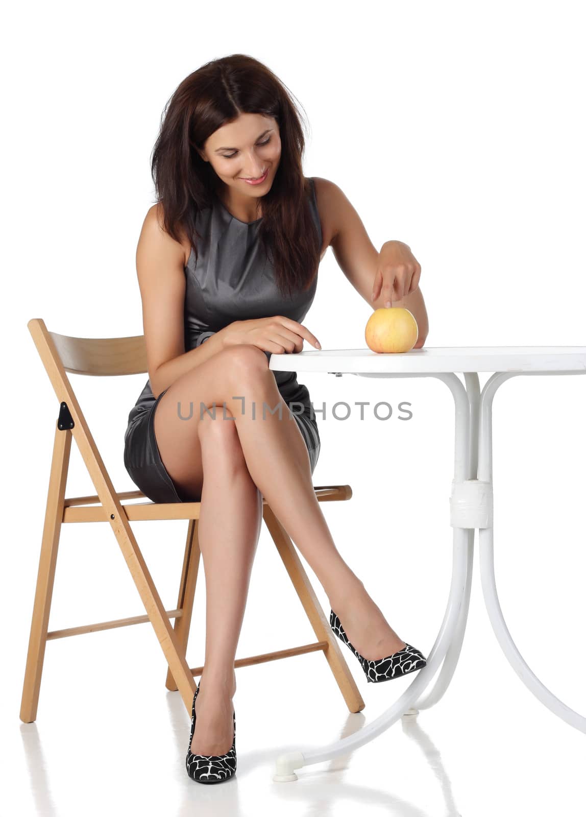 Girl with apple sitting on the chair