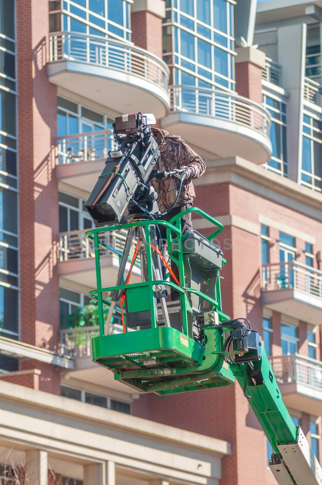 tv camera man recording event in a city on a lift by digidreamgrafix