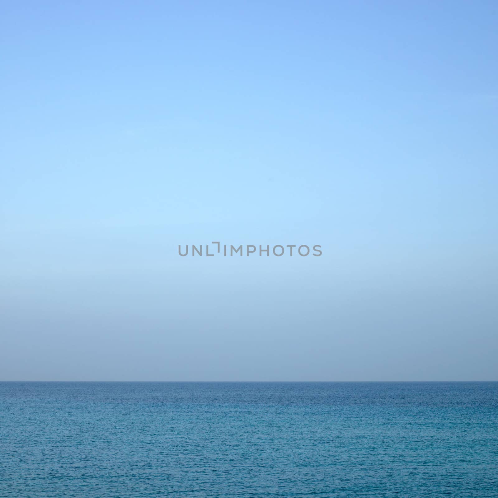 Beautiful turquoise wavy ocean with blue sky