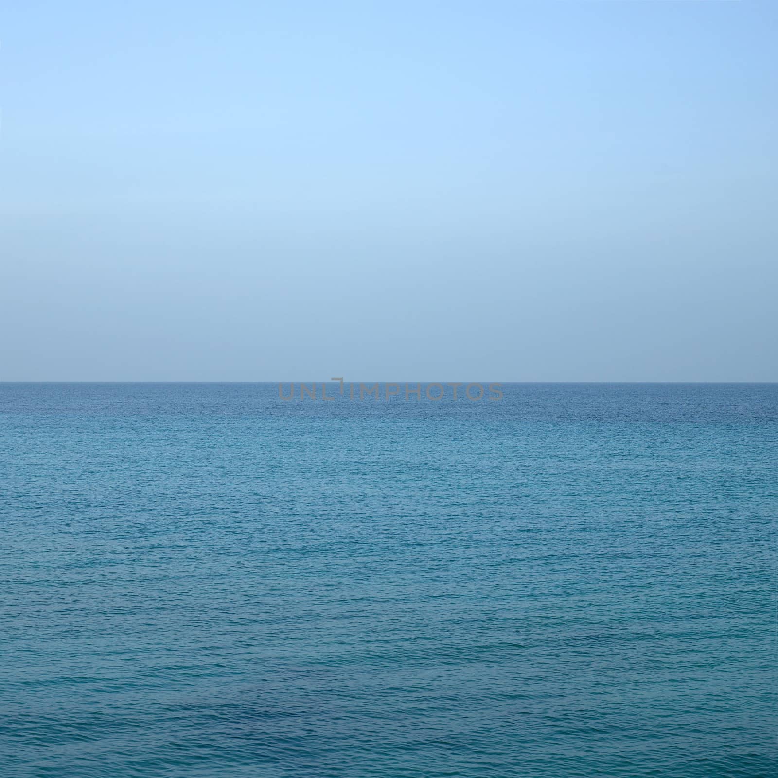 Beautiful turquoise wavy ocean with blue sky