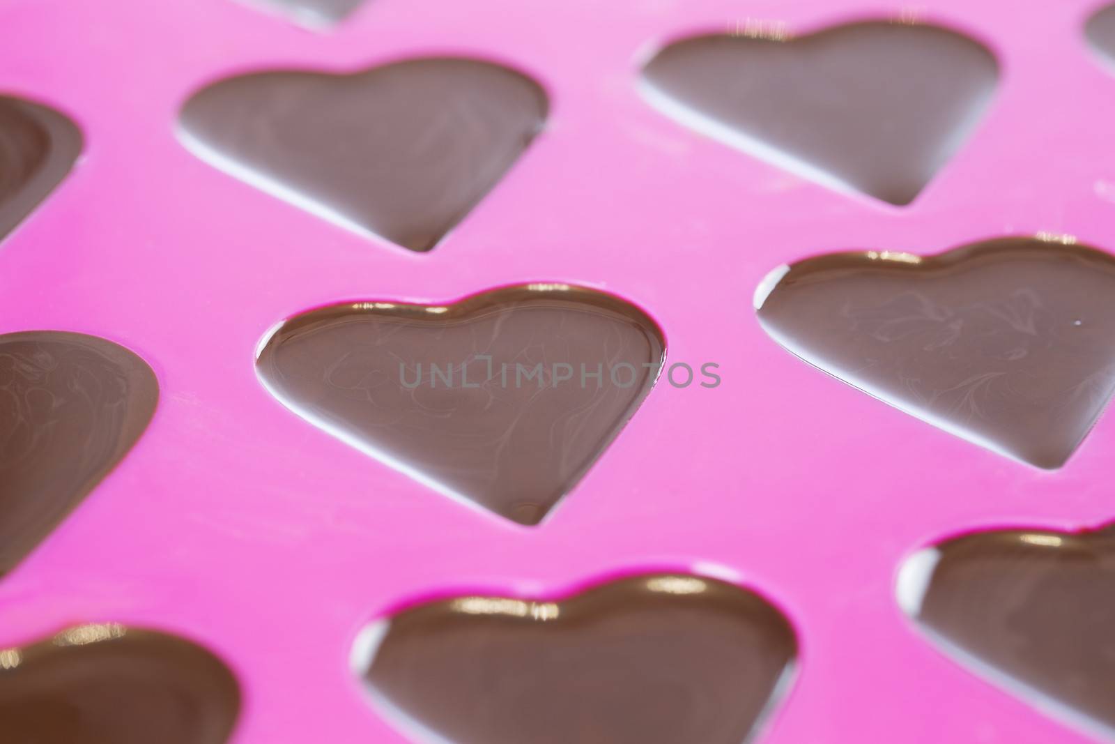 Close up of warm chocolate that has just been poured into a heart mold
